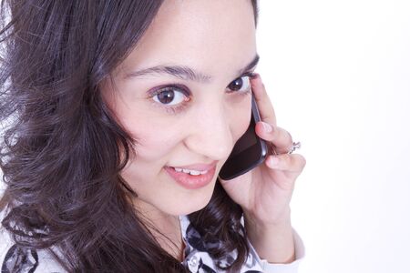 Mexican lady on the cell phone, looking up at camera, shot from above.の写真素材