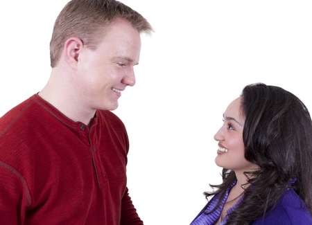 Blonde man and hispanic girl looking at eachother with love. Isolated on white.の写真素材