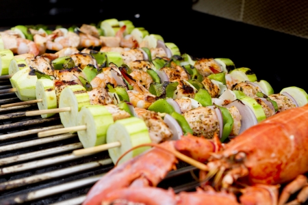 Salmon and Vegetable Skewers and Lobster are on the barbecue.の写真素材