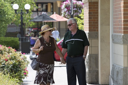 Happy senior couple looking at eachother at the street. Deciding what next to place to go.の写真素材