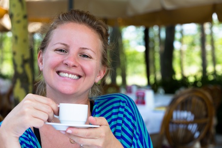 Nothing makes me happier  than a cup of Turkish coffee in the mornings. A large smile comes from a Turkish girl.の写真素材