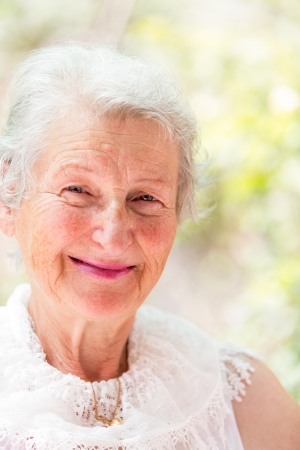Grandmother looking at you confidently with her white hair and complimenting nice clothing.の写真素材