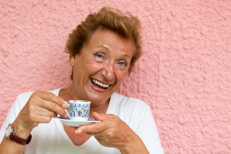 Older lady drinking her Turkish Coffee and giving caffeinated look の写真素材