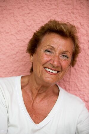 Older lady posing to camera with trusty lookの写真素材