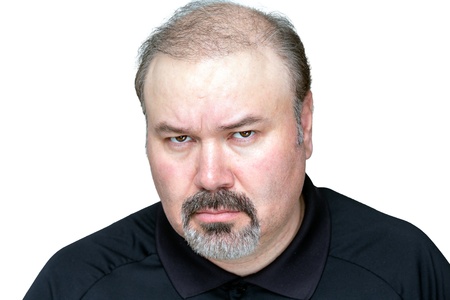 Angry man isolated on white, looking meanly.の写真素材