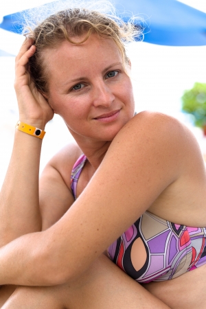 Woman with a bikiny looking at camera calmly and thoughtfullyの写真素材