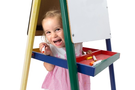 Girl smiling between whiteboard legs cheerfully and playfully, copy space on the whiteboardの写真素材