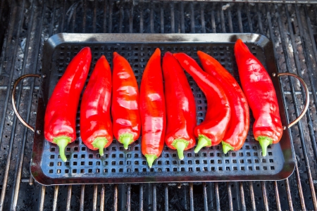 Chillies getting ready to be grilled on the grillの写真素材