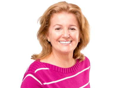 A blonde lady with pink sweater and greate great smile on her face perhaps feels good.の写真素材
