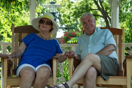 Retired Couple Resting in the Gazebo while holding each others handsの写真素材