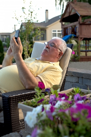 An old man using a cellular phone.の写真素材