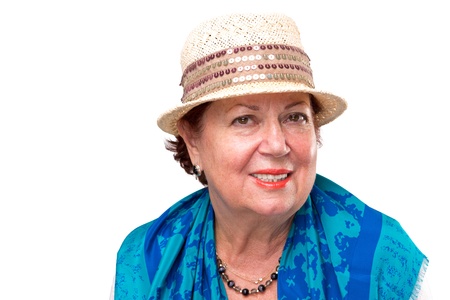 Senior woman posing with her fancy straw hat, she has blue color scarf on her shouldersの写真素材