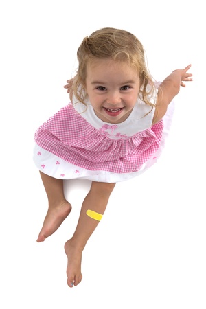 Two years old toddler girl smiling in her pink dress, shot from aboveの写真素材