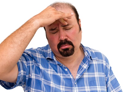 man looking worried with hand on forehead isolated on whiteの写真素材