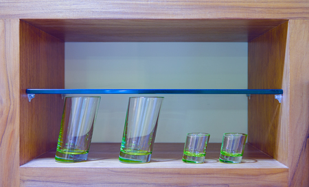 Four oblique glasses in wooden glass caseの写真素材