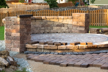 Pavers meets with patio island. Patio island have polymeric sand layed and job completion almost done when final pavers cut and placedの写真素材
