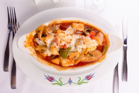 Chicken Saute baked with bell peppers, tomatoes, mushrooms and  chicken meatballs served in a oval shaped dish, top viewの写真素材