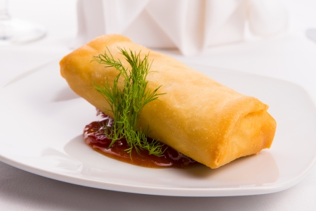 Spring roll complimented with dill served with sweet and sour sauce elegantlyの写真素材