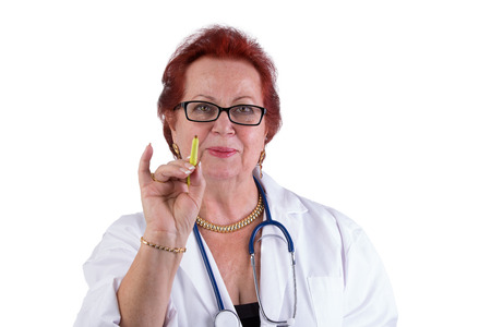 Senior Doctor making a point with her green pen , she has a genuine friendly look in her eyes, perhaps she expect you to get in to action with your healthの写真素材