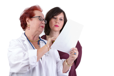 Female Doctor and her female patient discussing exam results, might be her blemish on her faceの写真素材