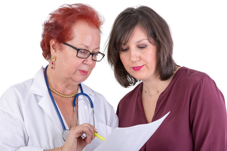 Female Doctor and her female patient discussing exam results, might be the payment optionsの写真素材