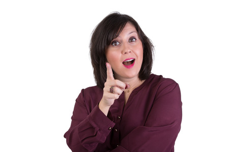 Middle aged businesswoman in shirt looking at your eyes with an idea and gesturing with her right handの写真素材