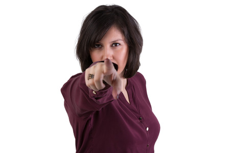 Middle aged woman pointing and looking at you, she might be choosing, wanting or blaming youの写真素材