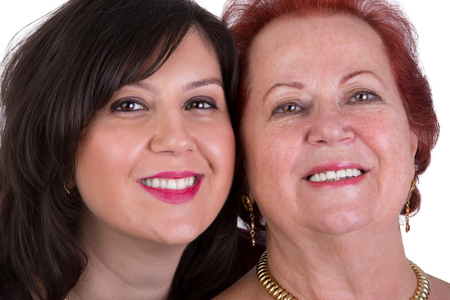 Senior mother and her middle age daughter cheek to cheek portrait, perhaps its motherの写真素材