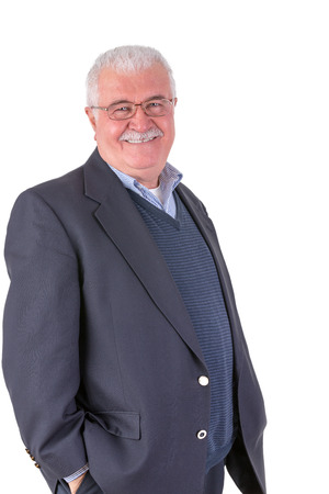 White hair senior adult looking at you smiling and satisfactorily with his glasses and his dark blue suitの写真素材