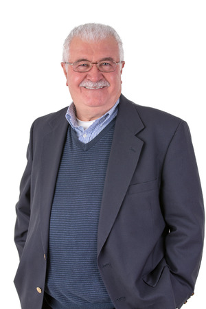 White hair senior adult with mustache looking at you smiling and satisfactorily with his glasses wearing dark blue suitの写真素材