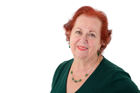 Senior lady with red hair looking in to your eyes kindly, isolated on whiteの写真素材