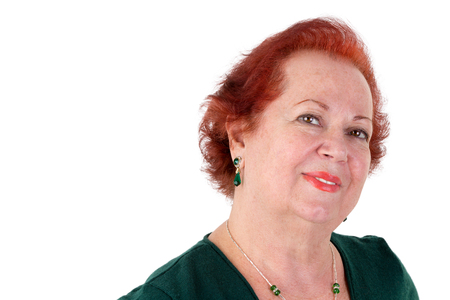 Mature adult lady with red hair looking in to your eyes meaningful and kindly, isolated on whiteの写真素材
