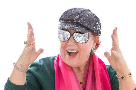 Senior lady dreaming for money and expressing her feelings happily with her hands, money reflection in her eyeglasses, perhaps she won the lottery ot getting big tax check from govermentの写真素材