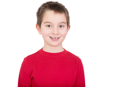 Young boy in a red t-shirt with a happy grin and alert expression, isolated on whiteの写真素材