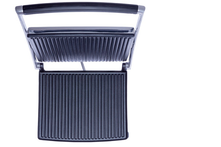 Open panini press viewed from above showing the empty clean cast iron plates suitable for your product placement, isolated on whiteの写真素材