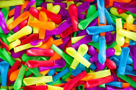 Plenty of Colorful Deflated Water Balloons for Summer Fun, Captured in High Angle View. Can be Used for Wallpaper Backgrounds.の写真素材