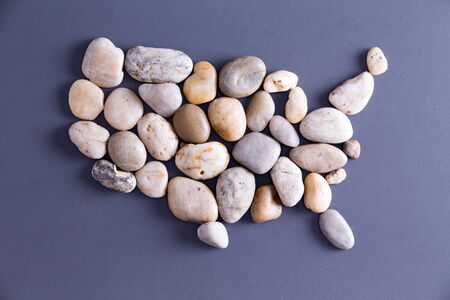 Map of United States of America, made of white and beige pebbles, concept of political power and stability, with copy space on blueの写真素材