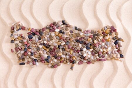 Travel concept with a creative Turkish map formed of colorful water worn agate and quartzite pebbles on decorative golden beach sand with a rippling wavy patternの写真素材