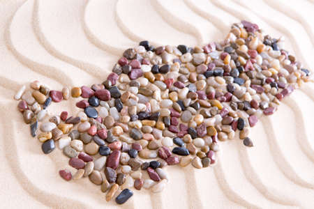 High Angle View of Map of Turkey Shaped from Colored Polished Pebbles on Wavy Beach Sandの写真素材