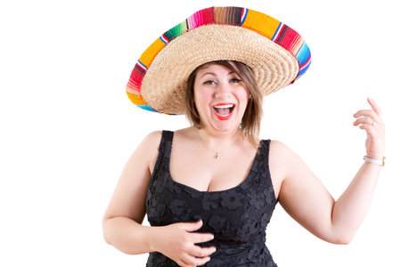 Close up Happy Portrait of a Dancing Lady in Casual Black Shirt with Mexican Sombrero, Looking at the Camera on a White .の写真素材