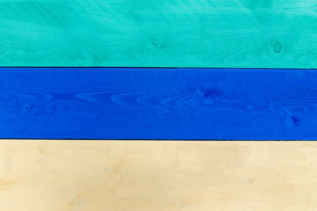 Background composed of wood planks in green, blue and cream colors and placed side by sideの写真素材