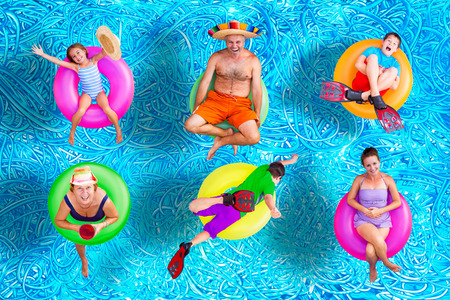 Family fun in the swimming pool in summer with a father, mother, grandmother, boys and a girl...