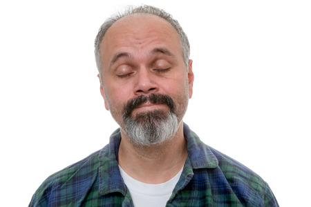 Man is waking up with acceptance on his face, his eyes closed perhaps still sleeping and dreamingの写真素材