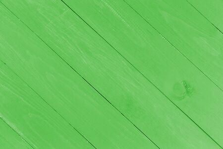 Blank slanted or diagonal wooden planks in fresh coat of green paint with copy spaceの写真素材