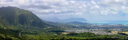 Panoramic view of Monalula Ridge and Kaneohe town looking towards a distant Kualoa Ridge on Oahu, Hawaii on a cloudy dayの写真素材