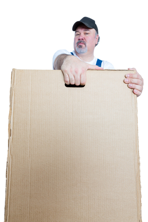 Man carrying large cardboard box against white backgroundの写真素材
