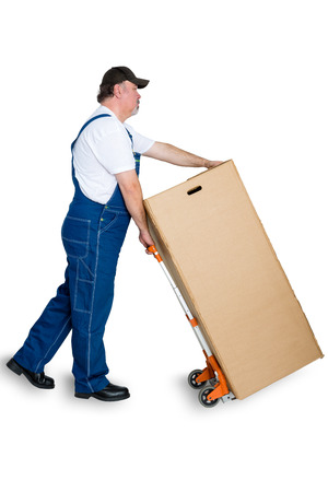 Mal worker delivering large cardboard box using cart against white backgroundの写真素材