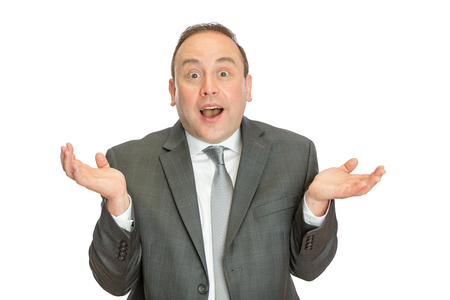 A portrait of a funny, comical business man in suit shrugging with a white  and copy space.の写真素材
