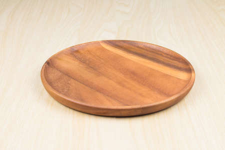 empty wood plate on wood table background / can be used display your productの写真素材