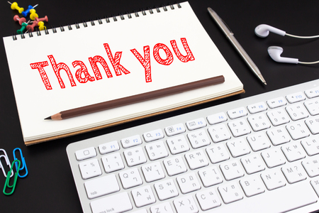 Word text Thank you on white paper on office table / business conceptの写真素材